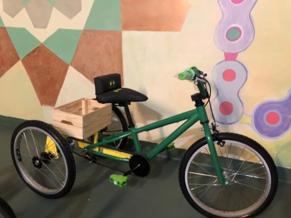 An adaptive bike with wooden crate on the back.