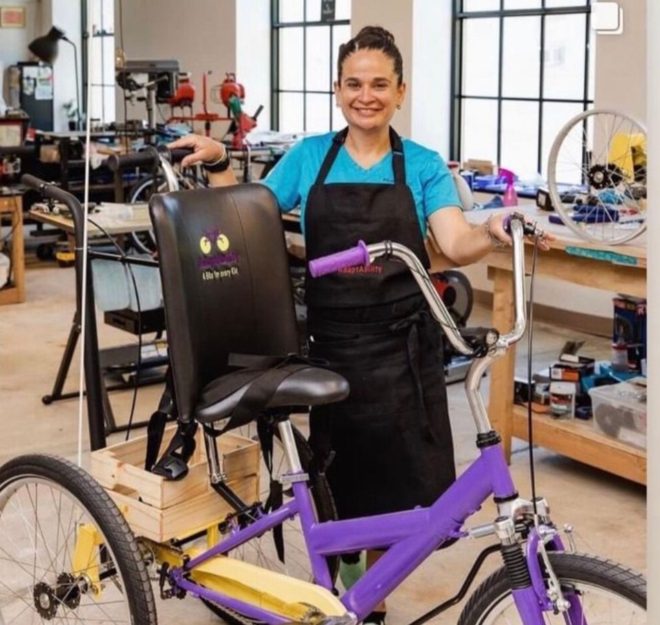 Adapt Ability founder, Sandra Alfonzo, standing next to an adaptive bike.