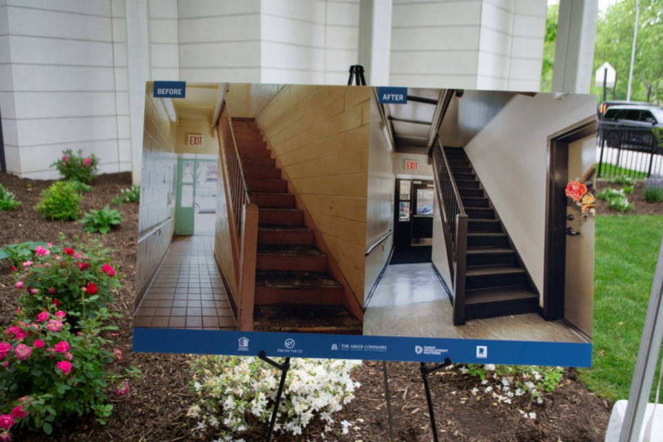 A poster showing a renovated staircase in one of the nine Brooklyn public housing developments renovated through a public-private partnership.