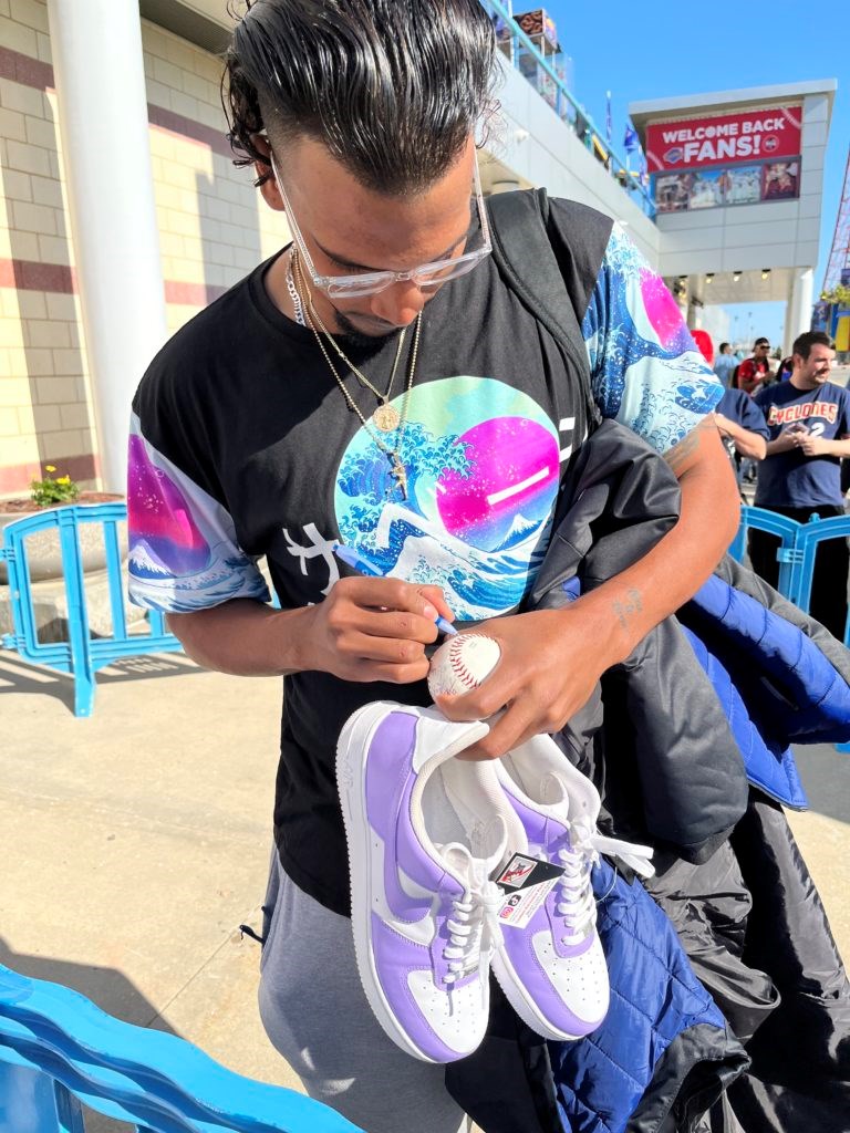 Sammy Tavares, a Brooklyn Cyclones pitcher, signing a ball while holding his brand new custom Air Force 1s. Photo: Junie Ortiz.