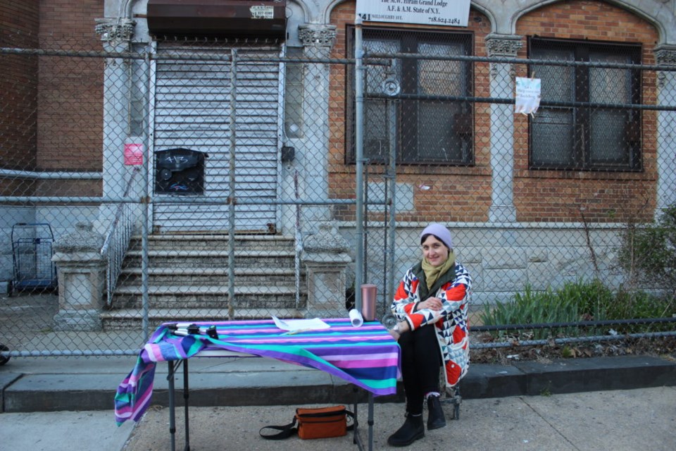 Lauren in front of 441 Willoughby raising awareness of her fight to landmark the building. Photo: Miranda Levingston for the BK Reader.