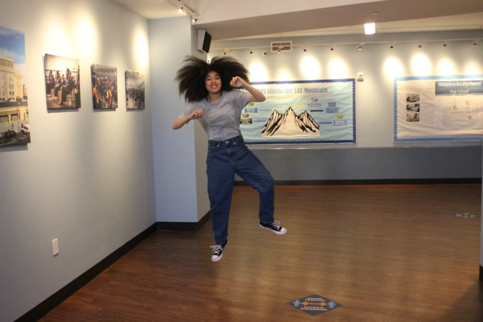 Myra Beji showing off a heel-click in the hallway at her school. Photo: Miranda Levingston for the BK Reader.