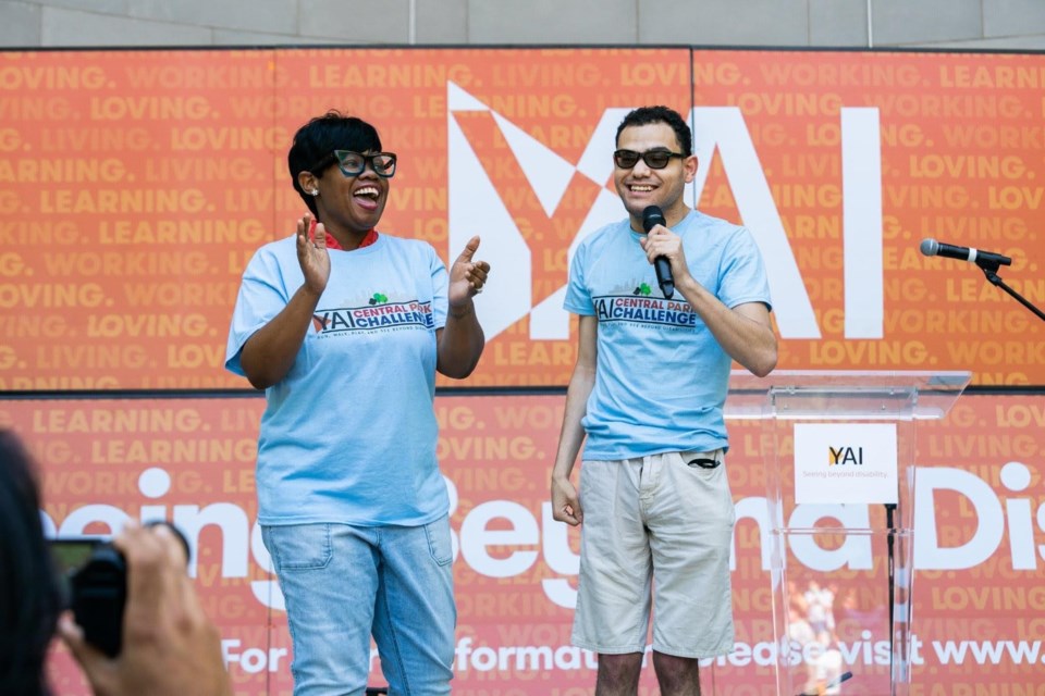 Marcelline Billy-Reid (left) and Laquane Suarez (right), standing next to each other on stage at the 2022 YAI Central Park Challenge.