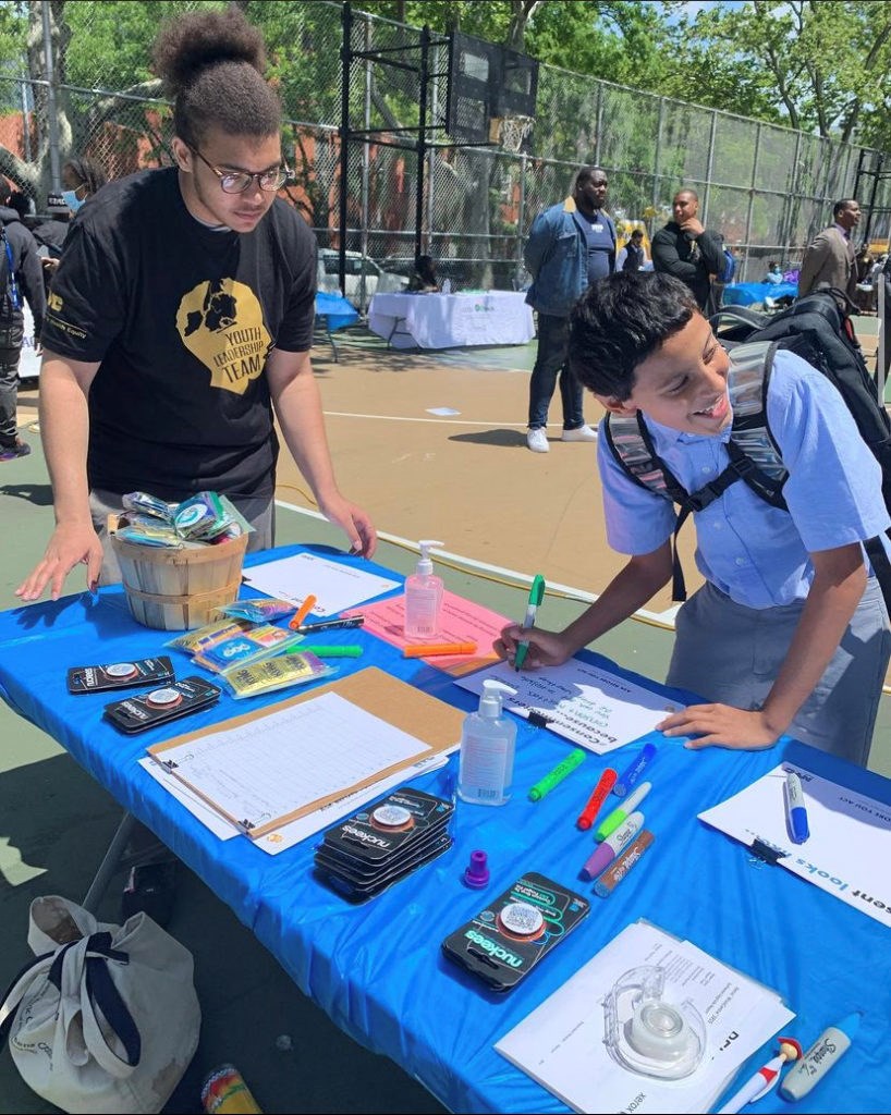 Javari Thomas running the booth as part of his role on the youth leadership team at Eagle Academy. Photo: provided by Javari Thomas. 