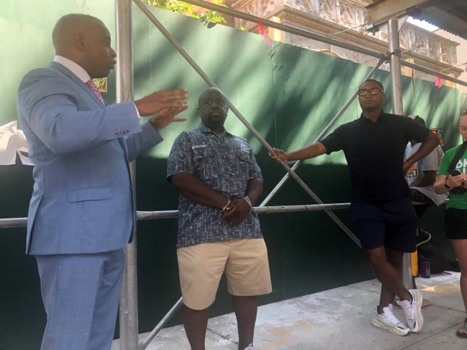 Christopher Fenelus, a representative for the organization that owns the building, addressed Chi Ossé at a community meeting outside the building on July 10. Photo: Miranda Levingston for the BK Reader.