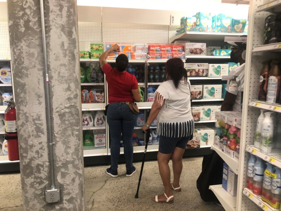 A Target employee grabbing a box of fabric softener for shoppers. Photo: Miranda Levingston for the BK Reader.