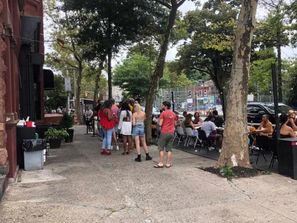 Sunday brunch at Peaches on Lewis Avenue is in full swing, complete with a roped-off line of people waiting for a table.  Photo: Miranda Levingston for the BK Reader.