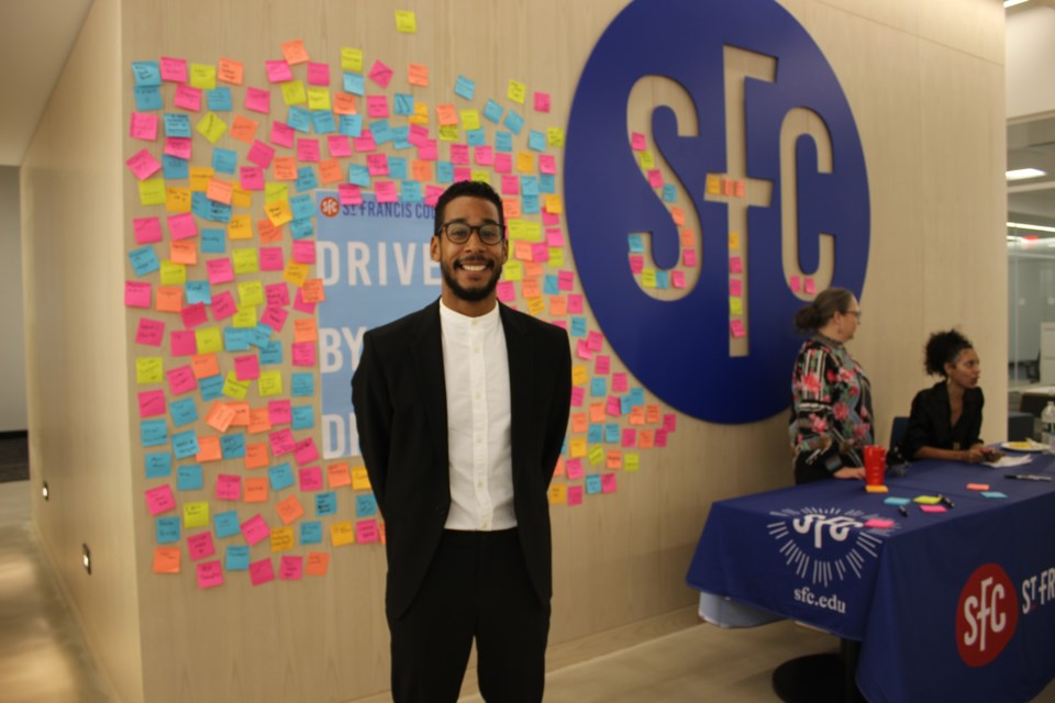 Borough President Antonio Reynoso poses with a post-it wall of students' dreams. Photo: Miranda Levingston for the BK Reader.