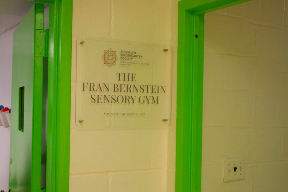 A plaque reads _Fran Bernstein Sensory Gym, dedicated Sept. 22, 2022."