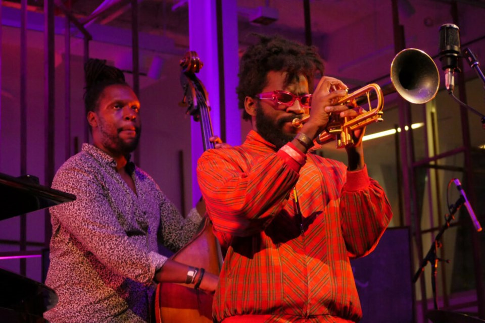 Giveton Gelin playing trumpet and Jonathan Michel playing bass during Julius Rodriguez's performance. Photo: Katey St. John for the BK Reader.