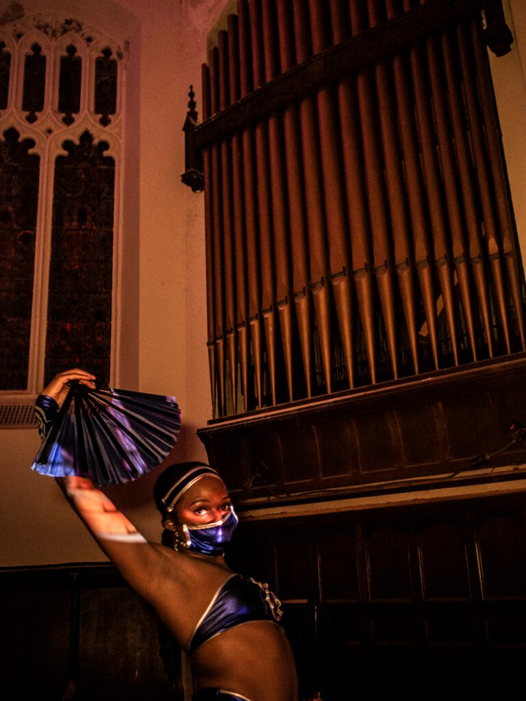 A partygoer posing with the church's original organ. Photo: Provided/ The Locker Room.