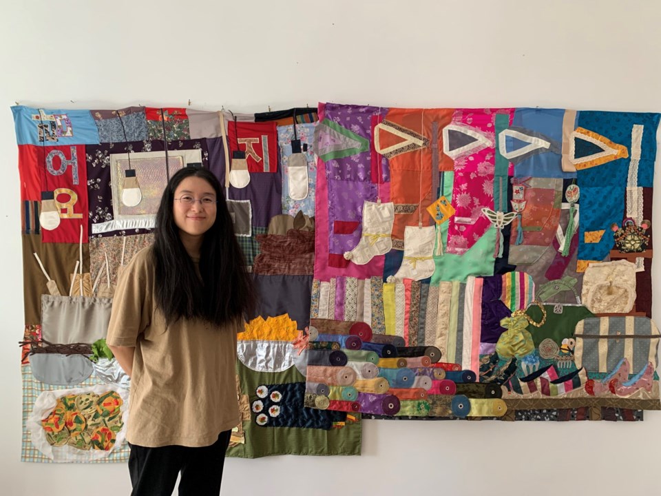 Woomin Kim by her quilts