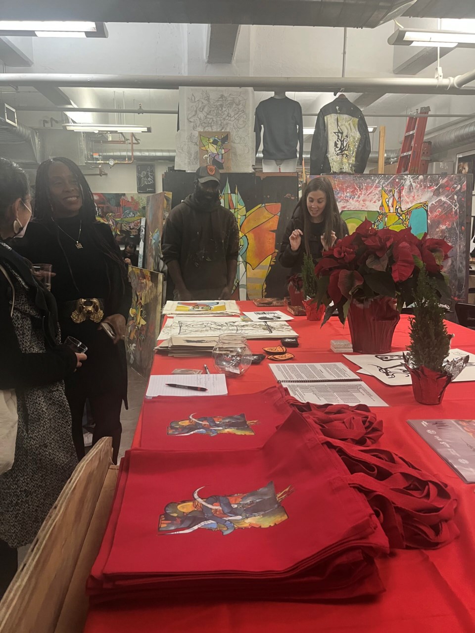 Craig Anthony Miller  shows visitors items to add to their gift giving list. 
Photo: Natasha Knows for BK Reader. 