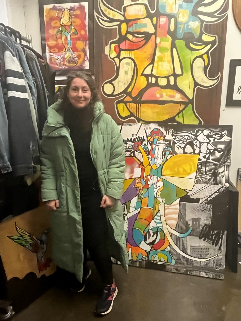 Alexandria Sica of the DUMBO BID checks out artist Craig Anthony Miller's work. 
Photo: Natasha Knows for BK Reader.