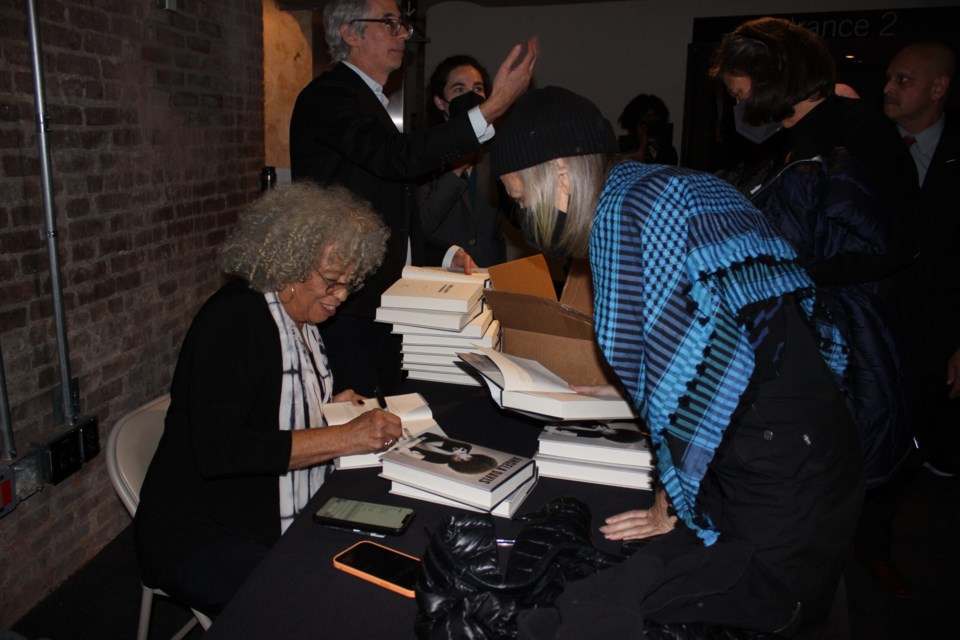 Davis signs books for a fan. Photo: Miranda Levingston. 