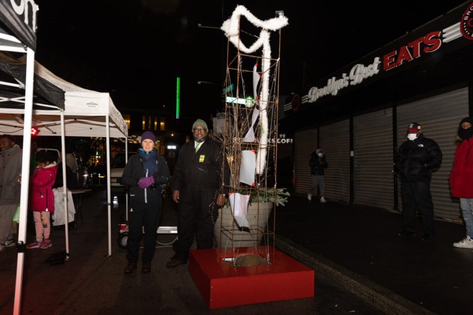 BID's President Kenneth Mbonu and artist Sari Nordman photographed together by the holiday tree.