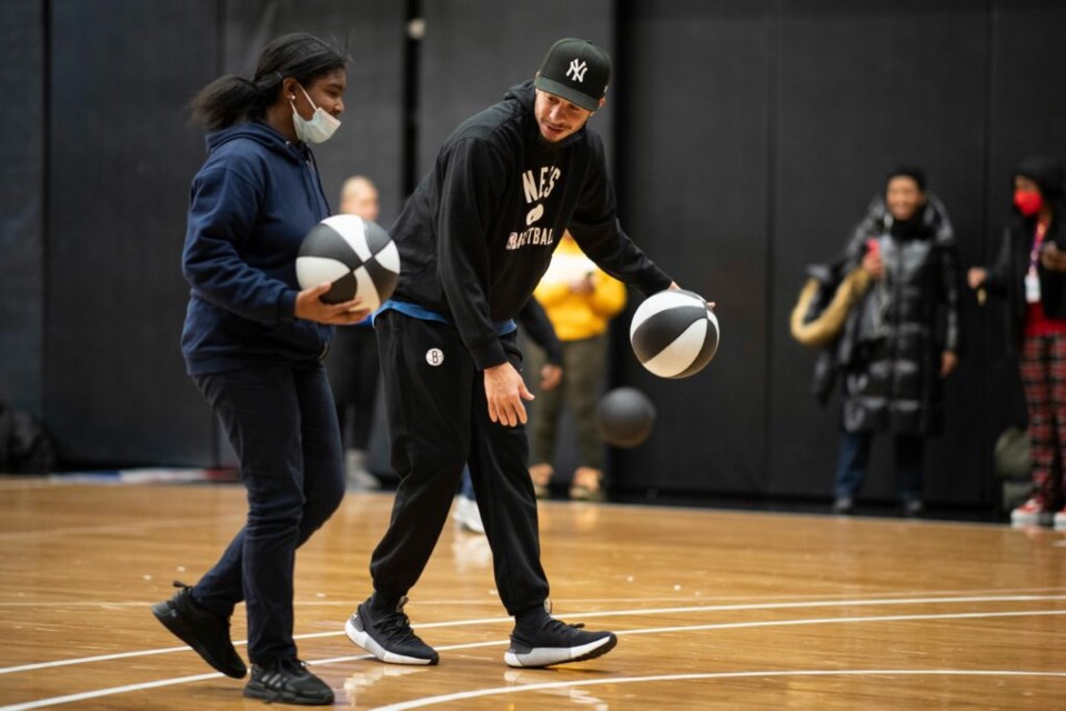 Brooklyn Nets Seth Curry on the court with student on NETSTEM Day at Barclays Center. Photo: Provided/ Brooklyn Nets.