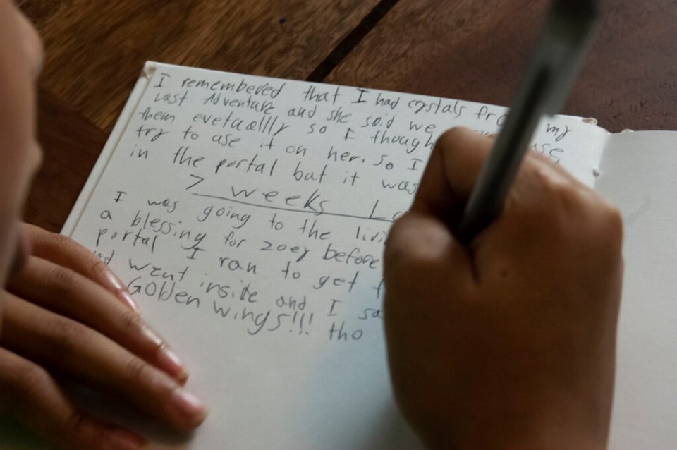 Amal Aminu working on her latest story. Photo: Provided/ Amal's sister, Lola Schiffer-Kehou, age 9.