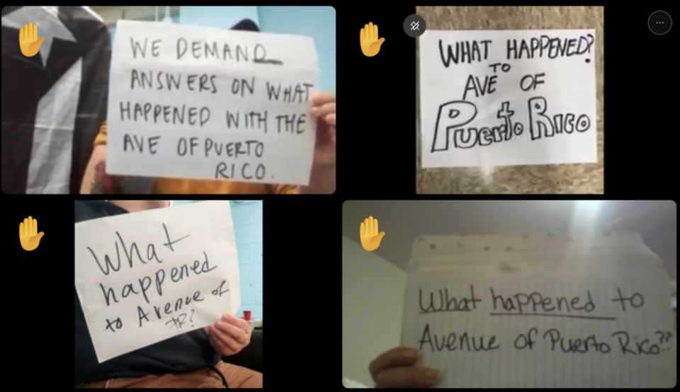 Some of the attendees of the meeting Tuesday held up signs as they waited to speak. Photo: Screenshot.