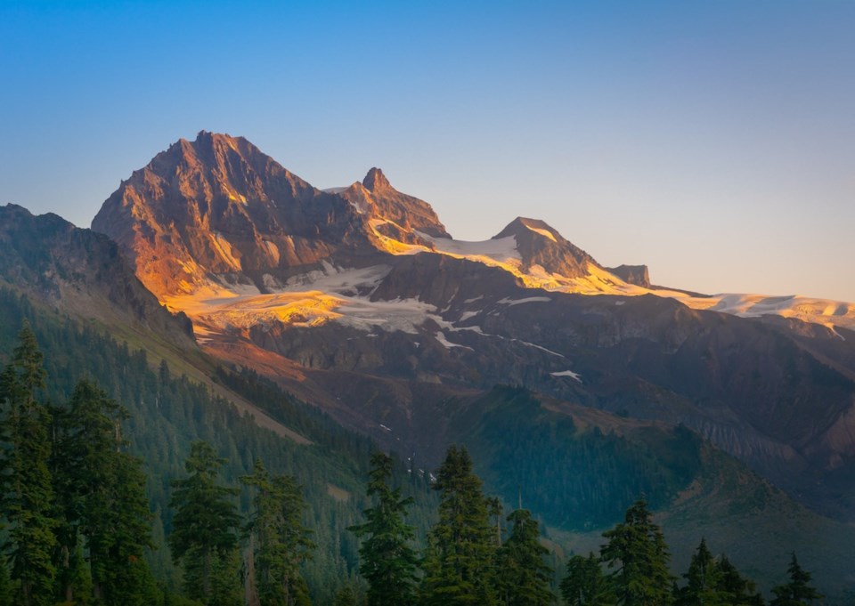 Sunset light hitting a jagged mountaintop