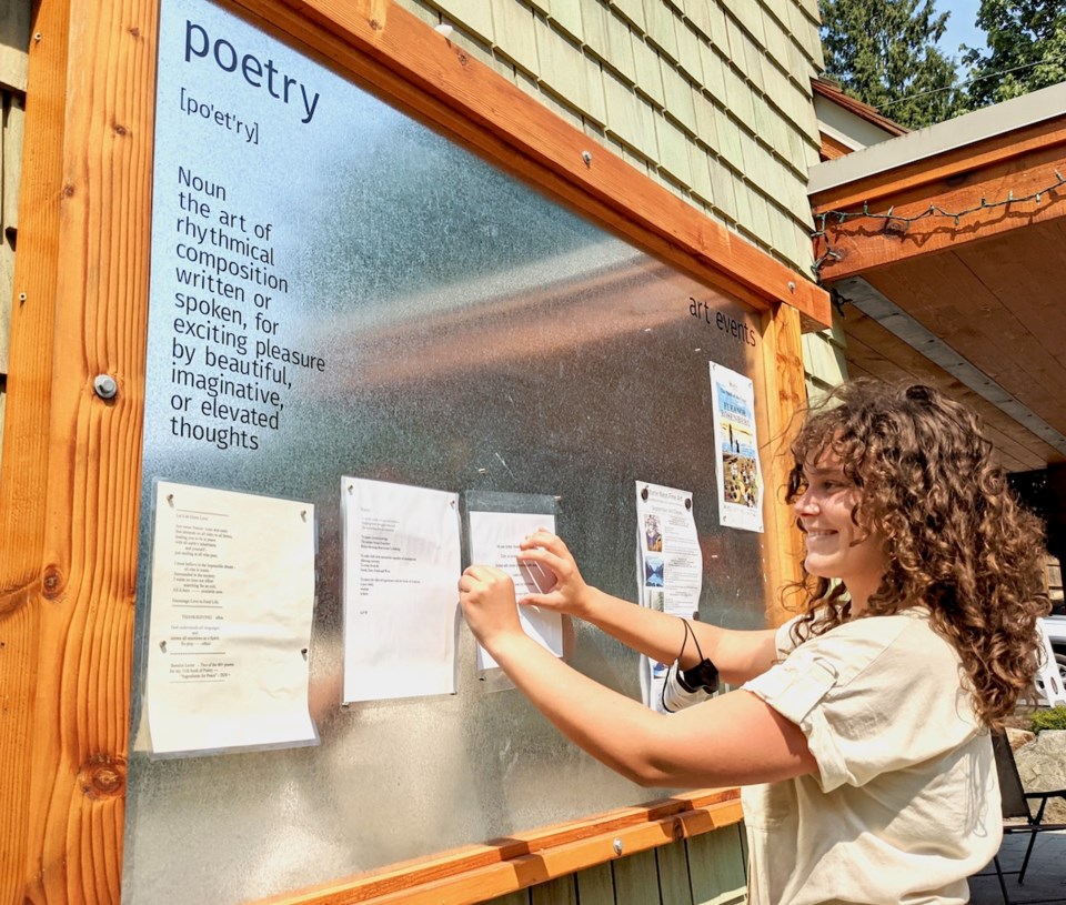 Matilda adjusting a poem on a poetry board