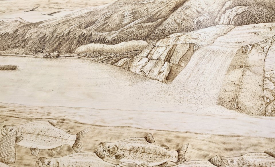 Pyrography scene of a waterfall and water