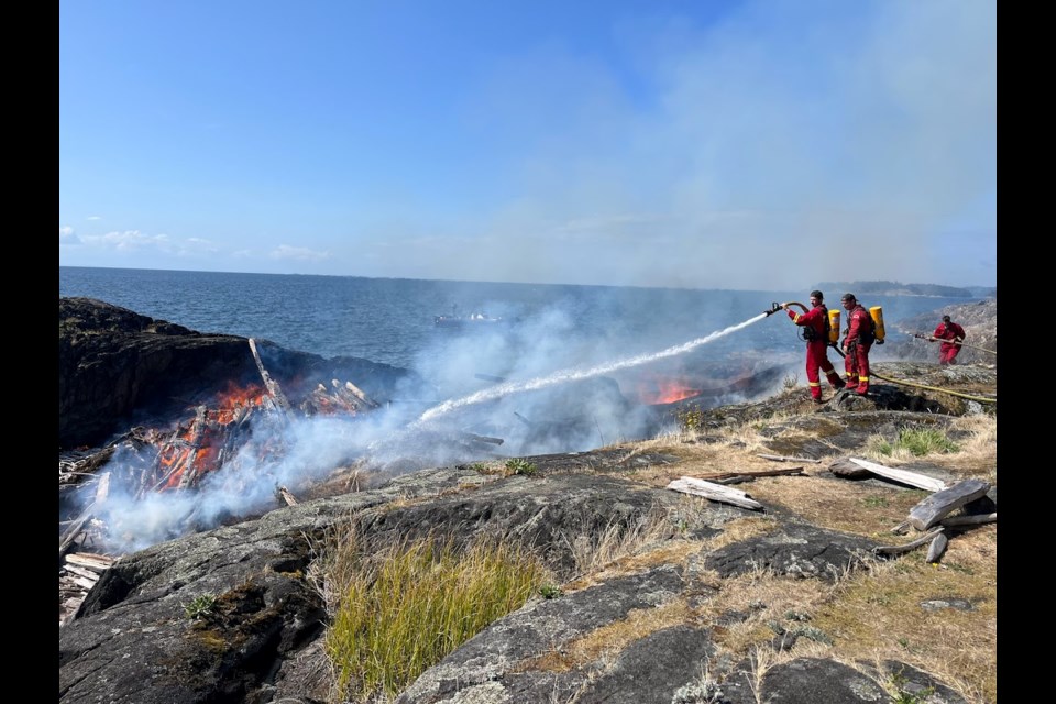 Firefighters arrive to deal with the blaze at Cape Roger Curtis. 