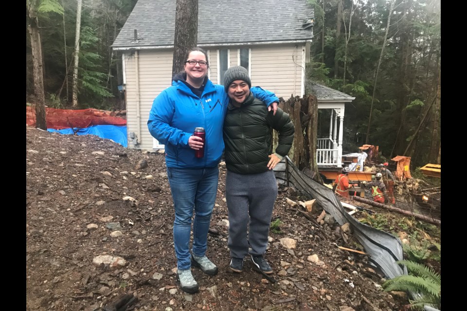 Homeowner Juan Ramos and residential designer Amy Adams admire the 1908 heritage house which was barged by Nickel Bros from North Vancouver to Tunstall Bay last week. The effort to move the home was complex and required many skilled people, but was ultimately successful. 