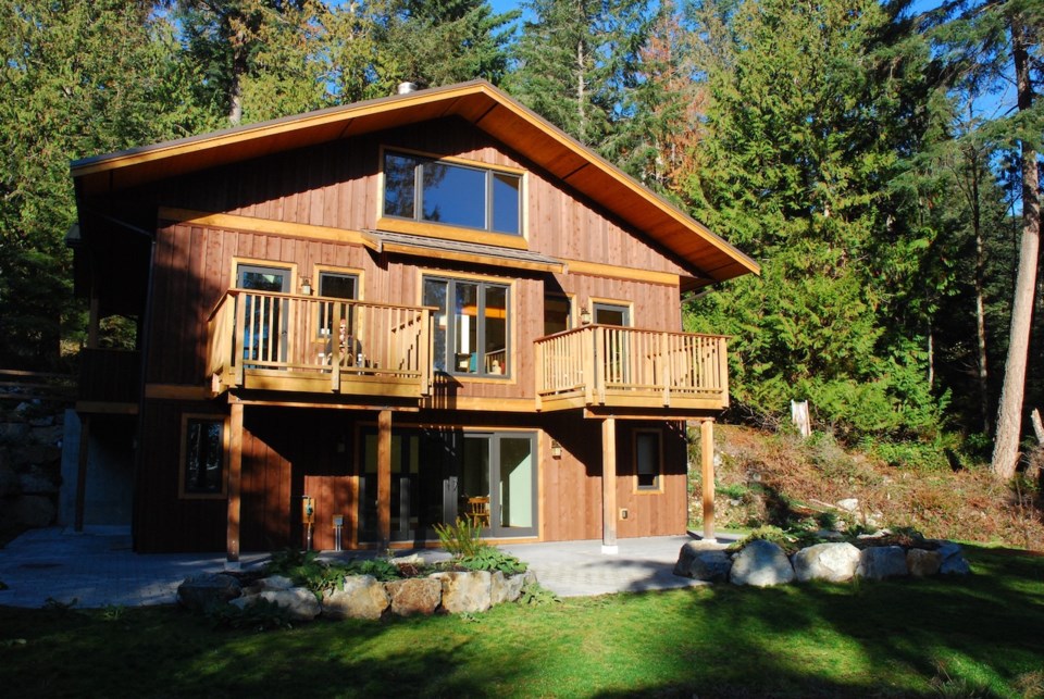 The two-storey Hermitage building in the woods