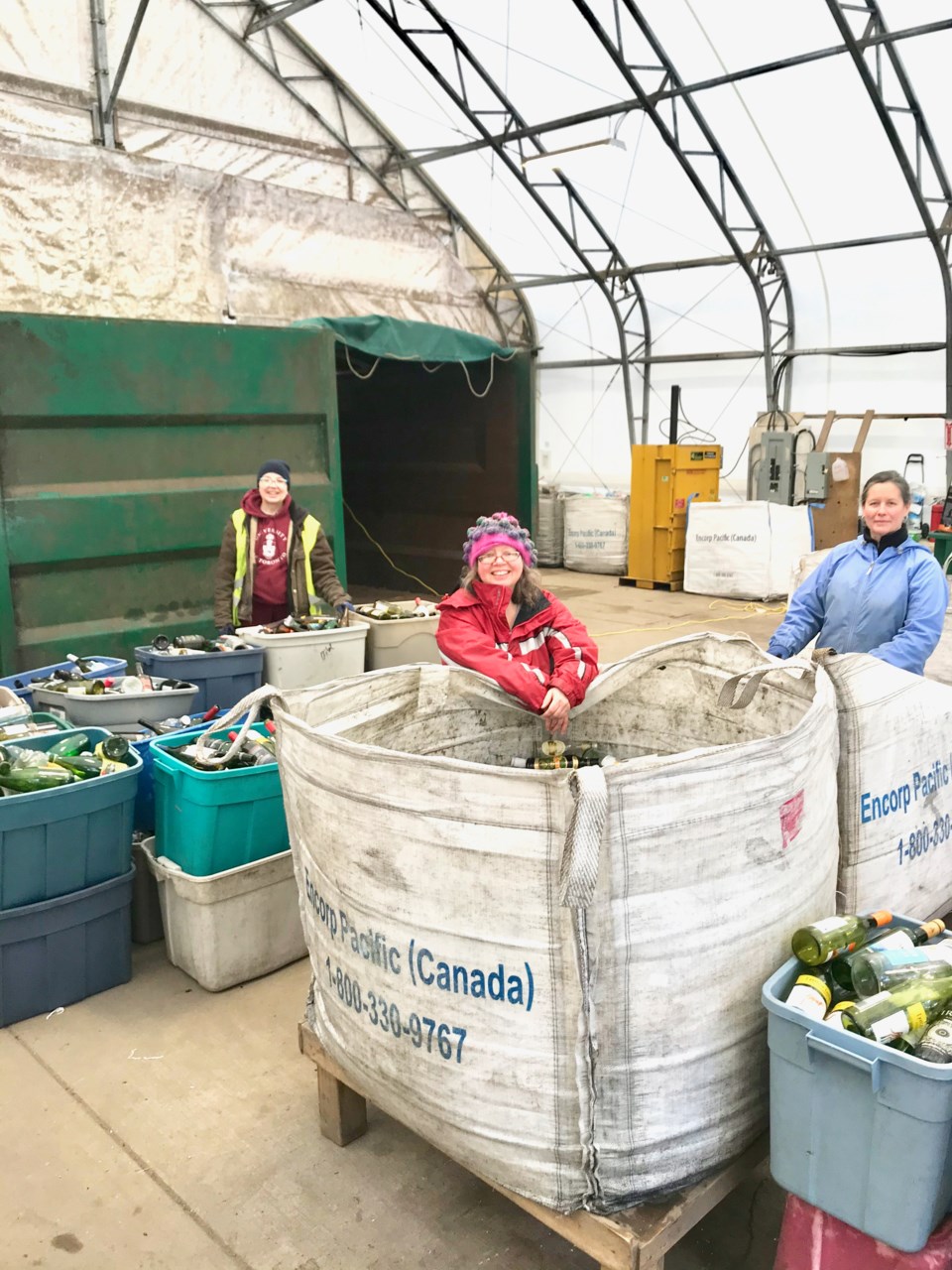 Three women with many bins of refundables inside BIRD