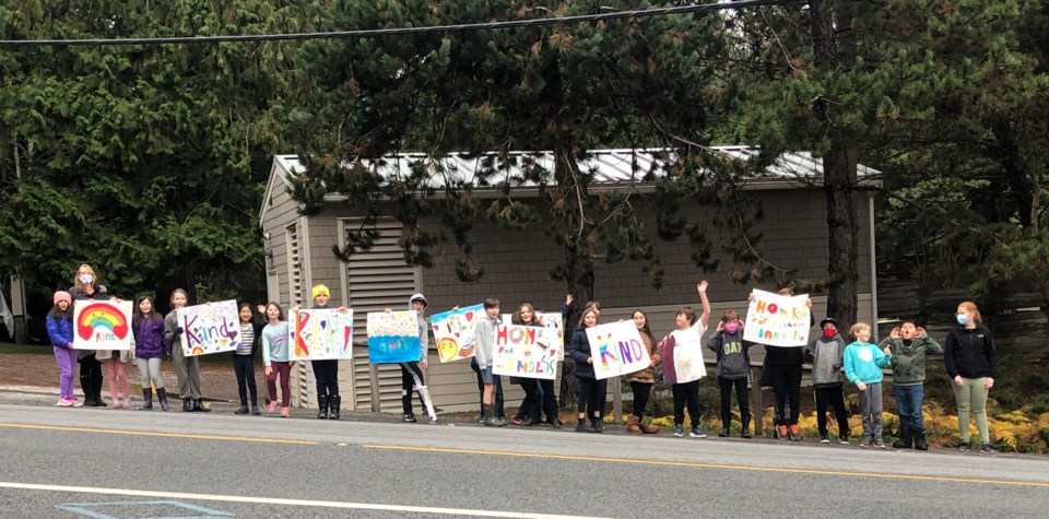 BICS students holding a 'kindness parade on Trunk Rd. 