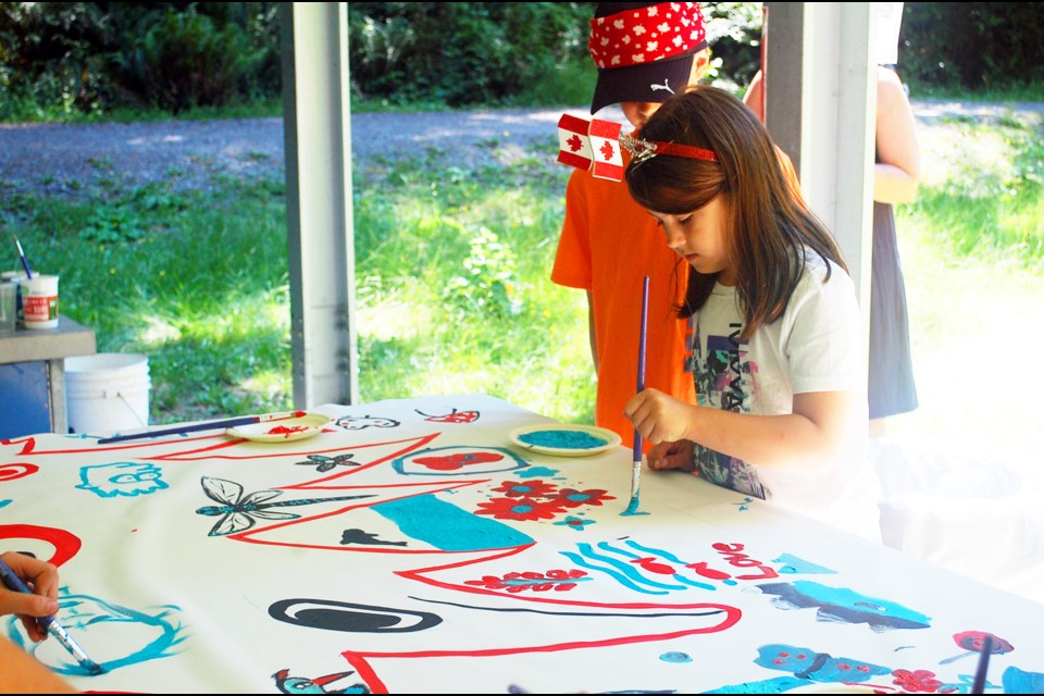 The Community Art project drew plenty of kids interested in leaving their mark. 