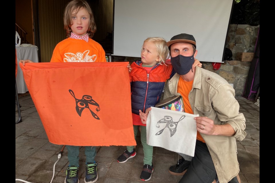 Franklin, Louie and Zac hold up their hummingbird flags.