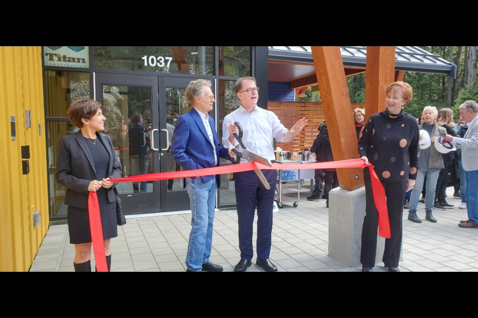 BC Health Minister Adrian Dix (white shirt) attended the opening ceremony of the Bowen Island Community Health Centre on April 15. Here, joined by the centre's Executive Director Suzanne Saatchi (left), Health Centre Foundation President Tim Rhodes (blue jacket), and centre Community Support Worker Colleen O'Neil (right), he explains that the novelty scissors make for a fun photo, but may not do as well of a job at actually cutting the ribbon. 