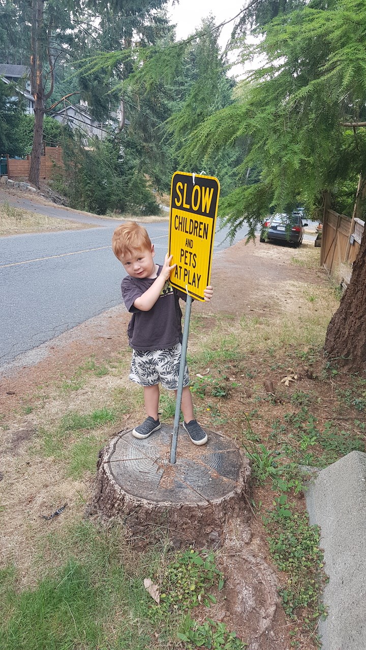 A child pointing at a slow sign in Tunstall Bay