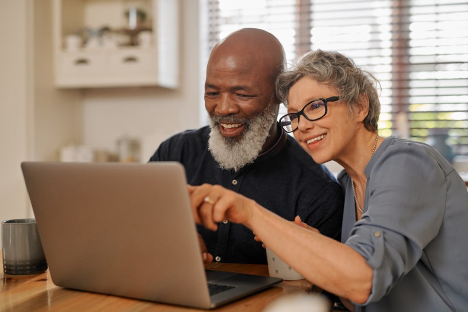 Cropped shot of an affectionate and happy senior couple using a laptop while relaxing together at home
