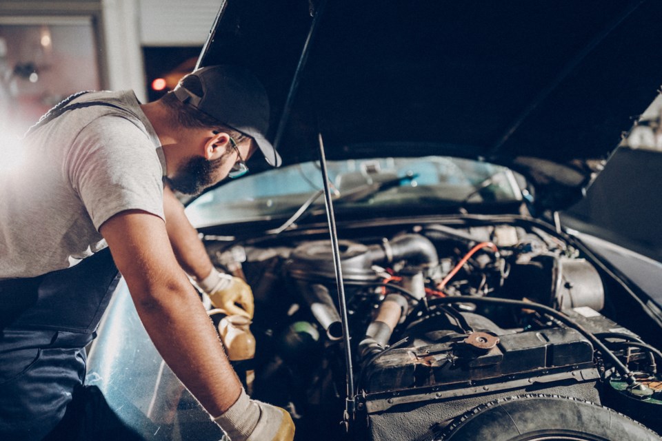 Man working on a car engine