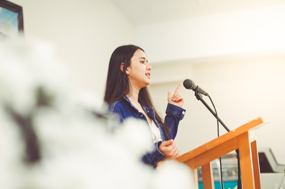 Woman at a platform talking