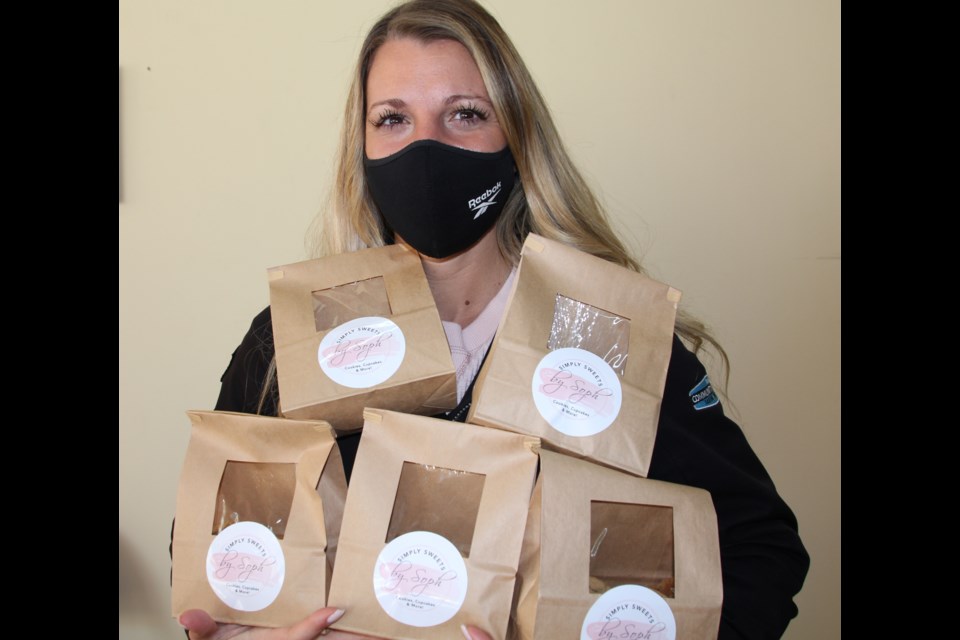Sophia Perugini of Simply Sweets sold home-baked oatmeal, chocolate chip, ginger-molasses and short bread cookies at the Parent Hustle Market Dec. 19