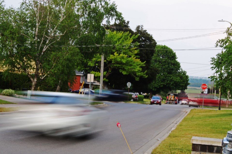 In this file photo, vehicles drive around parked cars on the way to and from the intersection of Scanlon Avenue and Nelson Street in Bradford.