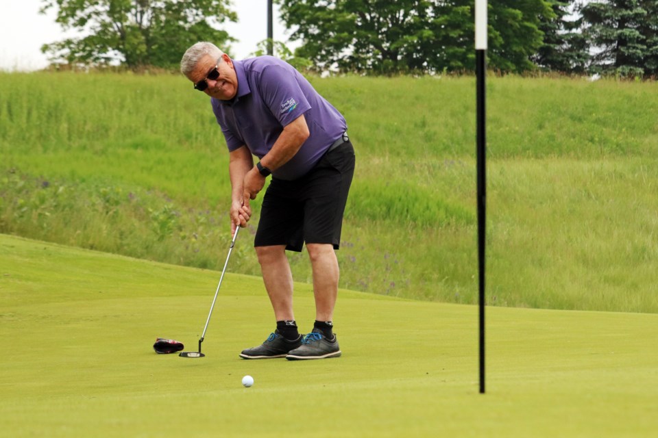 Mayor James Leduc tries for a tricky putt during the Mayor and Council’s Golf Classic, which raised funds for the new nature centre at Scanlon Creek Conservation Area and took place at The Club at Bond Head on Friday, June 16, 2023.
