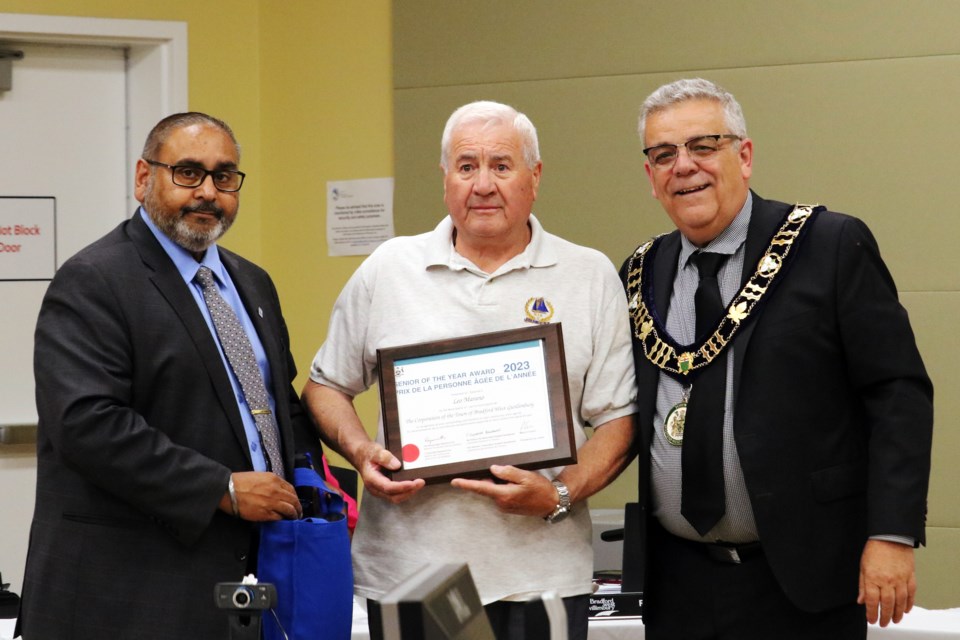 Leo Marano, centre, receives Bradford’s Senior of the Year award from Deputy Mayor Raj Sandhu, left, and Mayor James Leduc, right, during the regular meeting of council in the Zima Room at the Bradford West Gwillimbury Public Library on Tuesday evening, June 20, 2023.