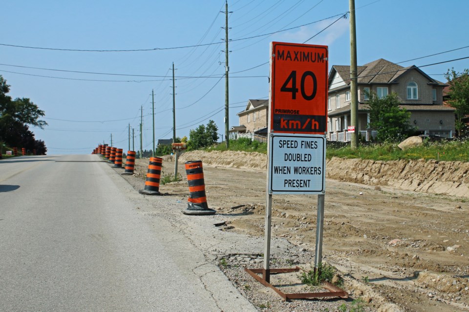 Signs and pylons can be seen along Sideroad 10 between Holland Street West and Line 6 as part of the South West Arterial Road project in Bradford in this file photo from July.