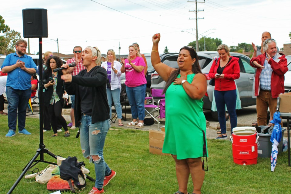 Katherine Grzejszczak, left, president of CUPE Local 905, and Nina Brown, vice-president, speak to the crowd of library workers, union members and supporters of striking workers of the Bradford West Gwillimbury Public Library during a rally outside the Bradford and District Memorial Community Centre Tuesday evening.