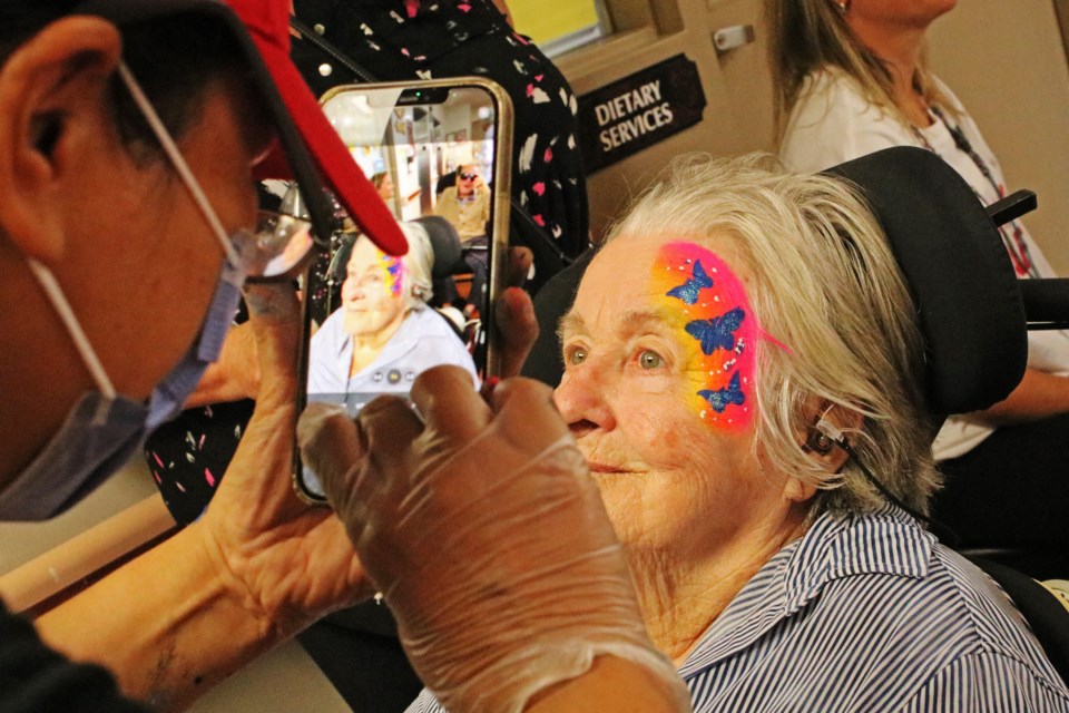 Peggy Burke has her face painted by Minerva’s Creations at Bradford Valley Care Community during the celebration of Bradford Valley’s 20th anniversary on Thursday.