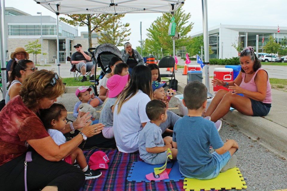 Michelle DeGasperis, right, hosts a storytime event from the picket line in an effort to continue offering programming to the community during the strike at the Bradford West Gwillimbury Public Library on Thursday.
