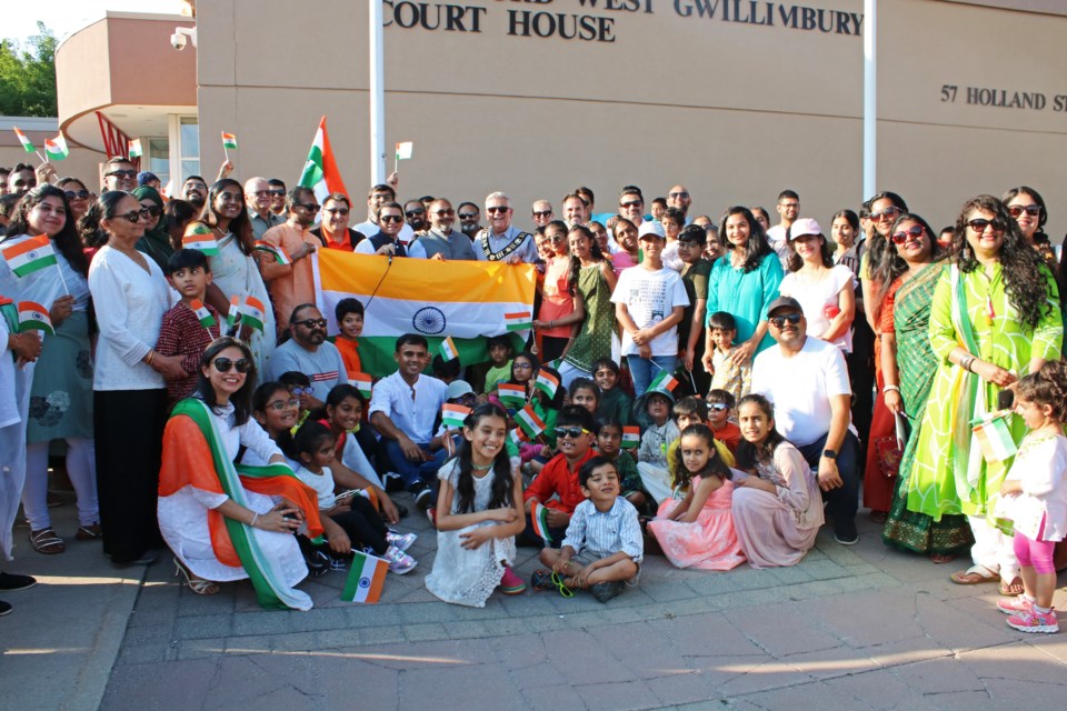 A large crowd of attendees, organizers and local politicians gather to celebrate Indian Independence Day with a flag raising at the Bradford West Gwillimbury Court House on Wednesday evening.