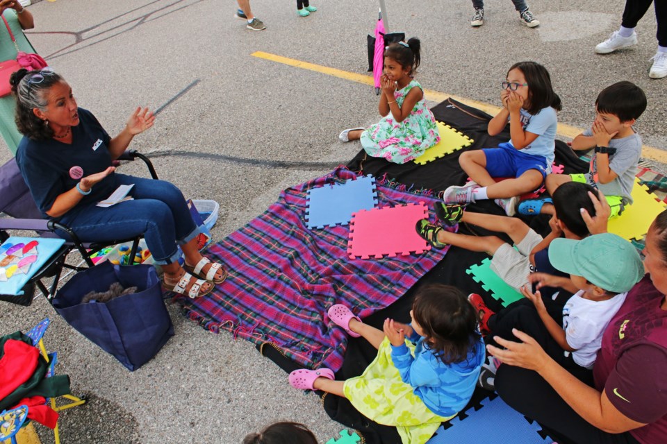 Michelle DeGasperis, leads a group of young children in songs and activities during a storytime event and community barbecue on the picket line at the Bradford West Gwillimbury Public Library on Thursday, Aug. 24, 2023.
