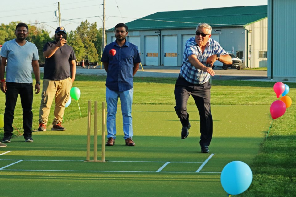 Mayor James Leduc throws the first pitch at the newly opened cricket field at Joe Magani Park in Bradford on Friday, Sept. 1, 2023.