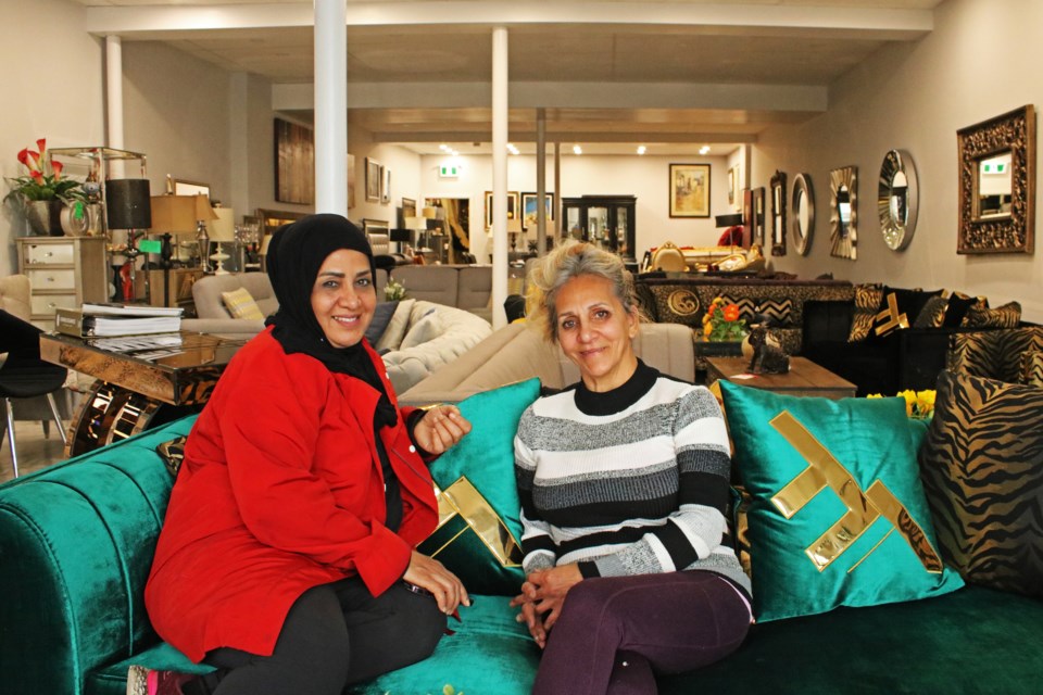 Faridah Ramsie (left) and her friend Forough Mahdavi take a seat on one of the sofas at New Mega Furniture on Oct. 26. The store will be having a grand opening at 11 Holland St. E. in Bradford on Oct. 28 at 2 p.m.